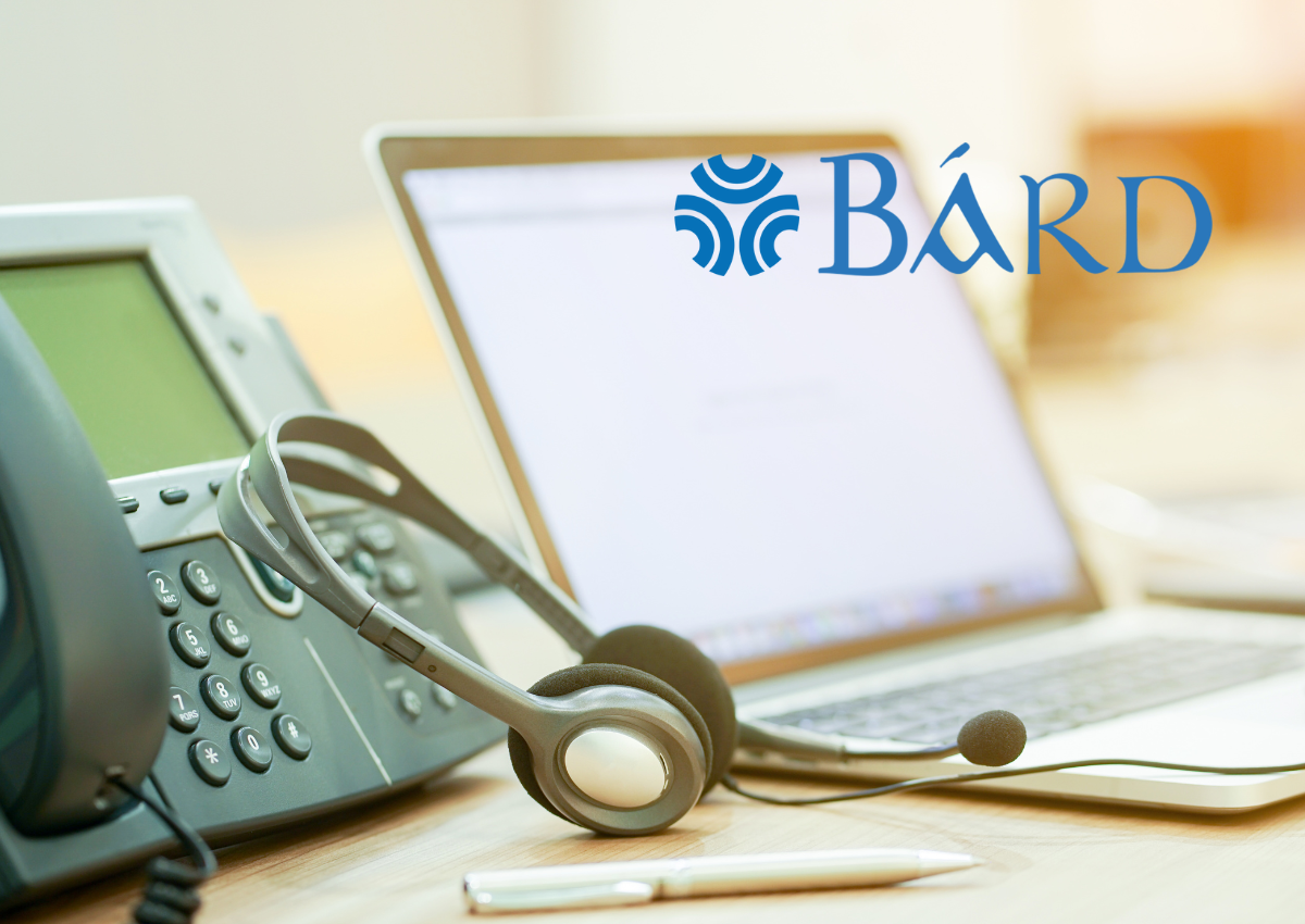 image shows a telephone and a laptop with a headset for customer service